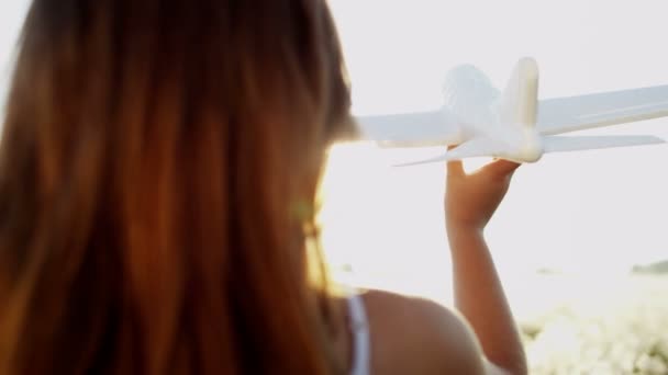 junges Mädchen spielt mit Spielzeugflugzeug - Filmmaterial, Video