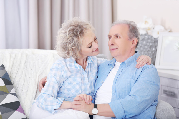 Mature couple embracing together - 写真・画像