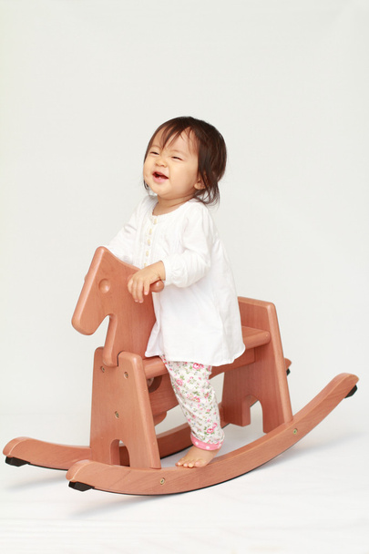 Japanese baby girl playing with rocking horse (0 year old) - Foto, imagen