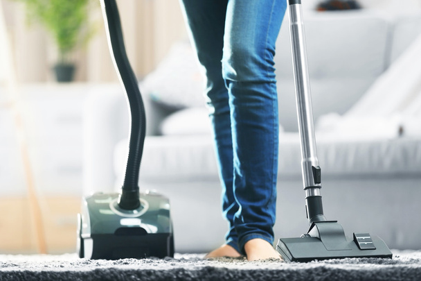 Woman cleaning the carpet - Фото, зображення