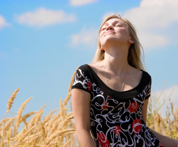Beautiful girl dreaming over blue sky - Photo, Image