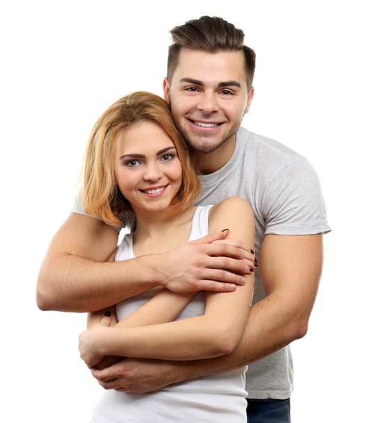 Νεαρό ζευγάρι στην αγάπη αγκαλιάζουν, να απομονωθεί σε λευκό - Φωτογραφία, εικόνα