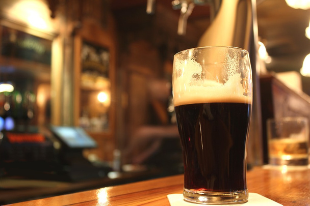 Dark beer served in a pub - Photo, Image