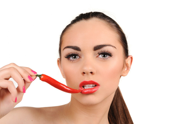 Young woman with chili pepper isolated on white - Zdjęcie, obraz