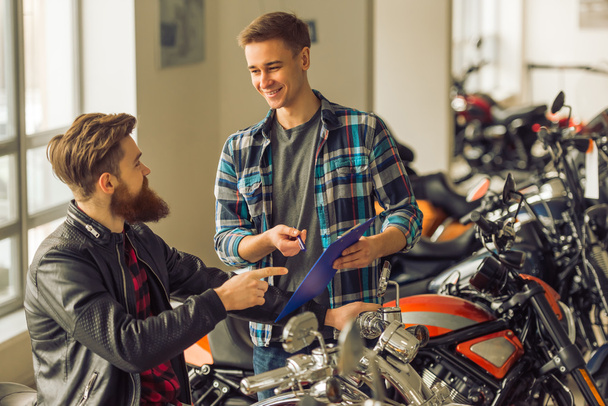 Men in motorbike salon - Photo, Image