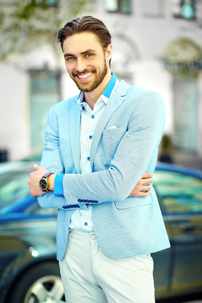 High fashion look.Young stylish confident happy handsome smiling businessman model man in blue suit cloth lifestyle in the street - 写真・画像