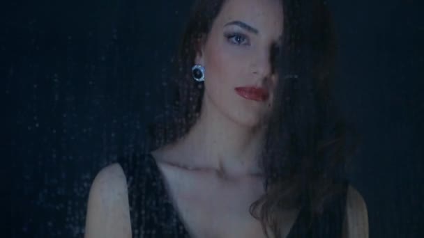 Close-up of a girl for a wet glass - Footage, Video