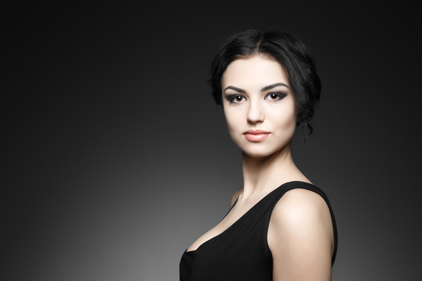 Portrait of beautiful female model on gray background - Foto, imagen