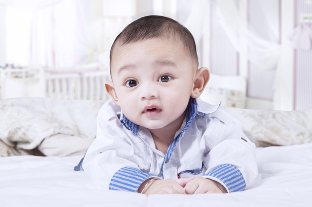 Cute baby boy crawling in the bedroom - Foto, immagini