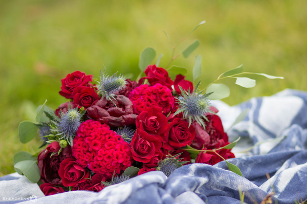 Bright marsala bouquet with blue scarf on green grass - Photo, image