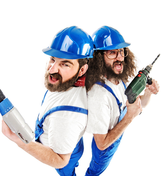 Conceptual picture of two builders while working - Φωτογραφία, εικόνα