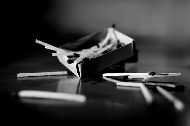 Match box and match sticks lying on floor monochrome - Φωτογραφία, εικόνα