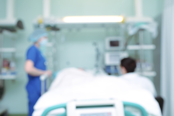 Nurse talking to visitor at the patient bedside, unfocused backg - Valokuva, kuva