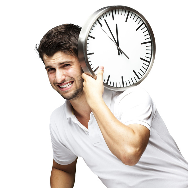 Portrait d'un beau jeune homme portant une horloge contre un blanc
 - Photo, image