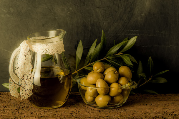 Olives and olive oil in glass jar - Photo, Image