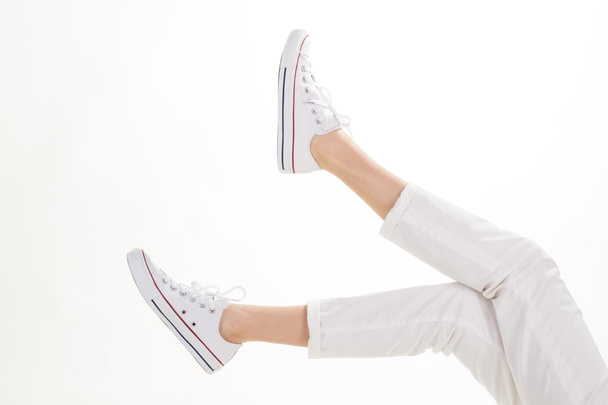 White trousers and casual footwear. - Фото, зображення
