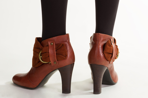 Woman's brown ankle boots. - 写真・画像