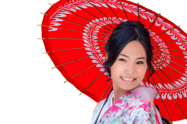 Jeune femme japonaise isolée avec un parapluie rouge
 - Photo, image