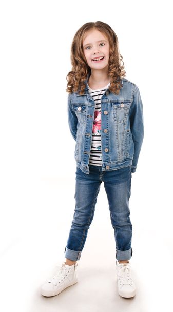 Portrait of adorable happy little girl in jeans - Фото, изображение