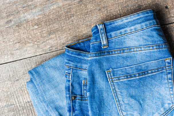Blue jeans on old wooden surface - Φωτογραφία, εικόνα
