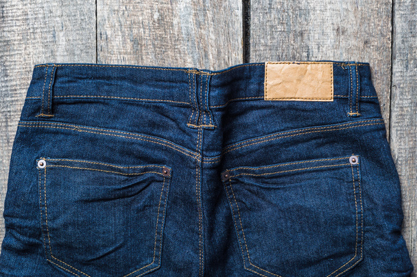 Blue jeans on old wooden surface - Fotó, kép