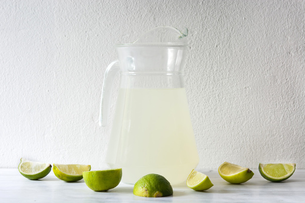 Freshly squeezed juice lime on wo - Photo, Image