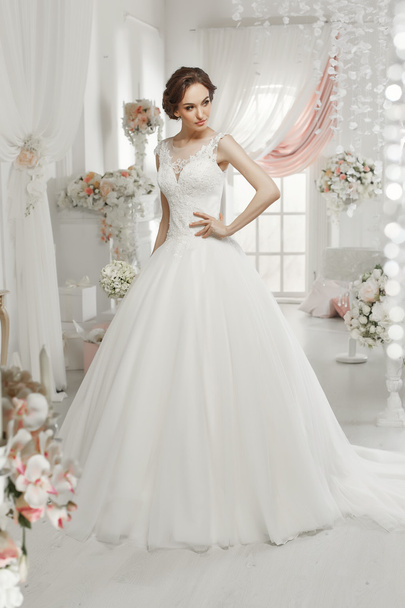 The beautiful woman posing in a wedding dress - Zdjęcie, obraz