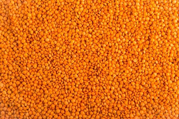 Dry unbroken orange lentils texture - Photo, Image