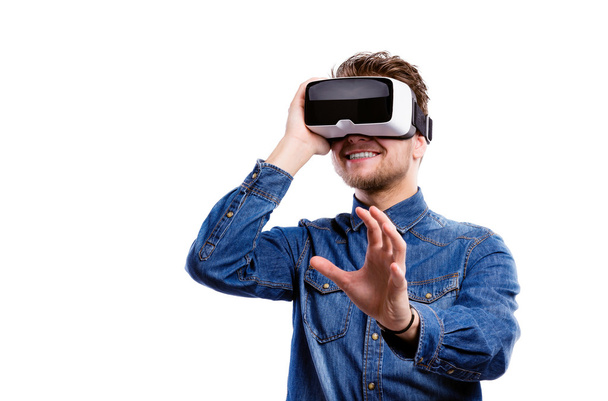Man wearing virtual reality goggles. Studio shot, white backgrou - Photo, image