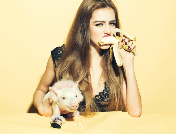 Woman with pig and banana - Valokuva, kuva