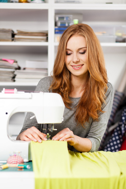 Young woman at a sewing machine - Photo, Image