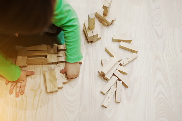 Hand of baby who played developmental game of wooden blocks lumb - Photo, image