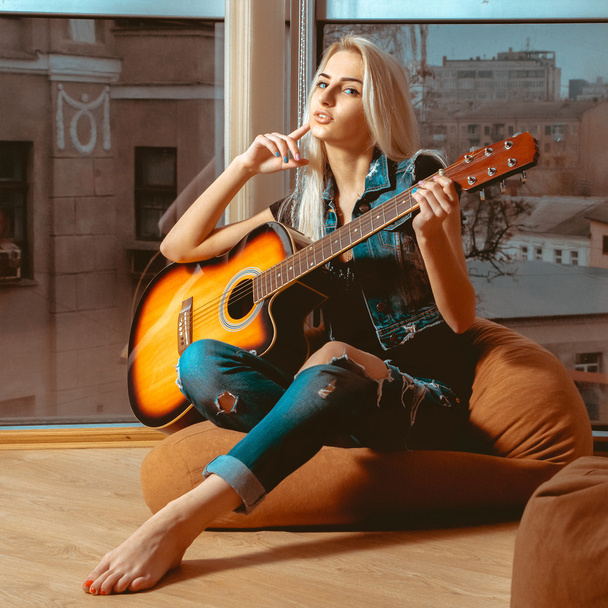 square picture modern young girl with a guitar in hands - Foto, Bild