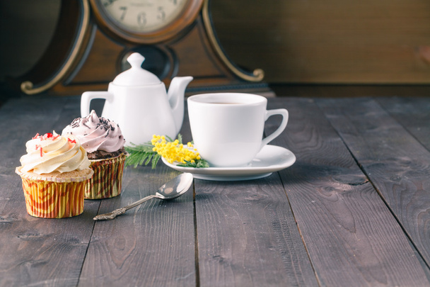 Two cupcakes on dark wooden table - Foto, imagen