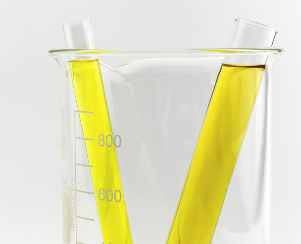 Test tube with yellow liquid (fluid, water) in the beaker for ch - Photo, Image