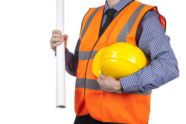 Building Surveyor in orange visibility vest carrying yellow hat - 写真・画像
