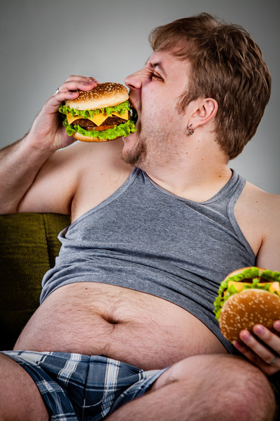 Fat man eating hamburger - Фото, зображення