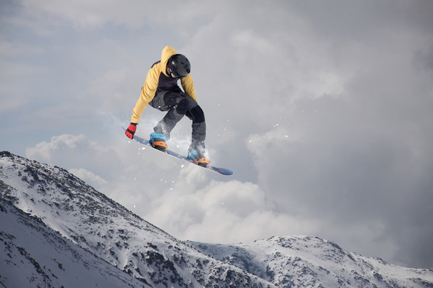 Flying snowboarder on mountains. Extreme sport. - Photo, Image
