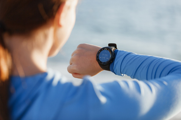 Runner woman with heart rate monitor running on beach - Foto, Bild