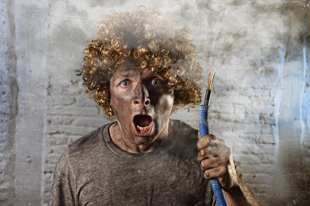 man with cable smoking after domestic accident with dirty burnt face shock electrocuted expression  - Φωτογραφία, εικόνα