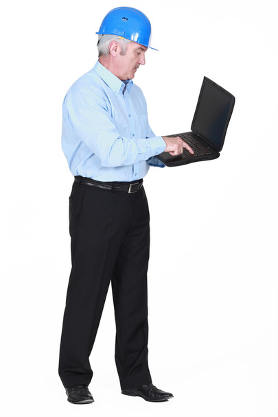 Senior architect typing on laptop - Photo, image