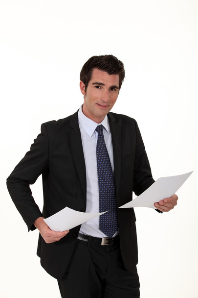 Businessman stood with two documents - Фото, зображення