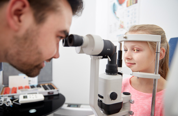 optician with tonometer and patient at eye clinic - Фото, зображення