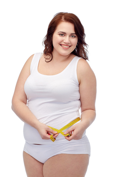 happy young plus size woman with measuring tape - Zdjęcie, obraz