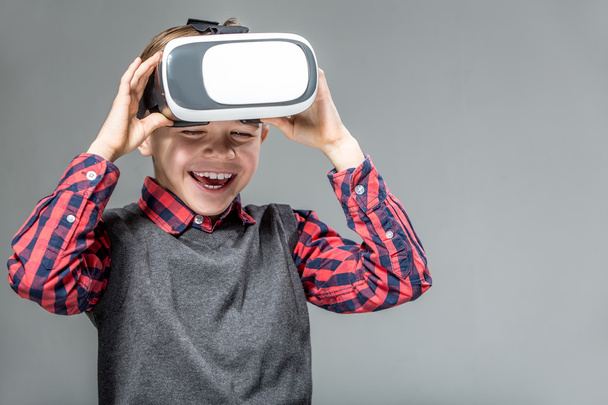 Boy in virtual reality glasses playing the game - Фото, зображення