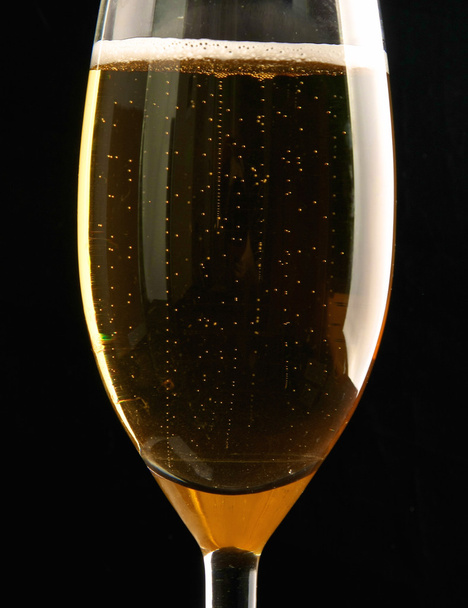 A glass of sparkling champagne on black background - Zdjęcie, obraz