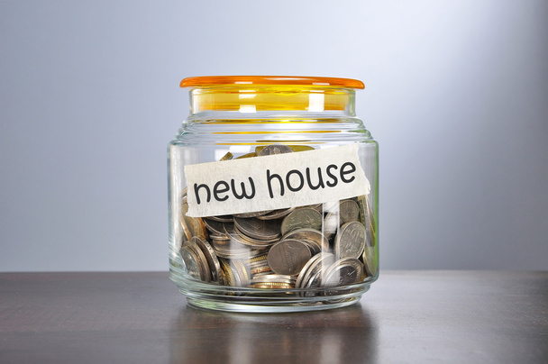Saving concept of coins in the glass jar for new house  purpose - Foto, Imagen
