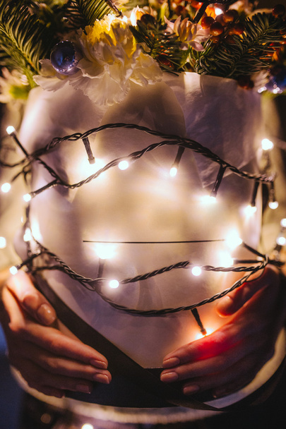 Girl holding bouquet with Christmas lights - Foto, Bild