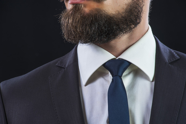Bearded man in suit on black background - Фото, изображение
