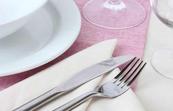Table setting with fork, knife, plates, and napkin - Fotoğraf, Görsel